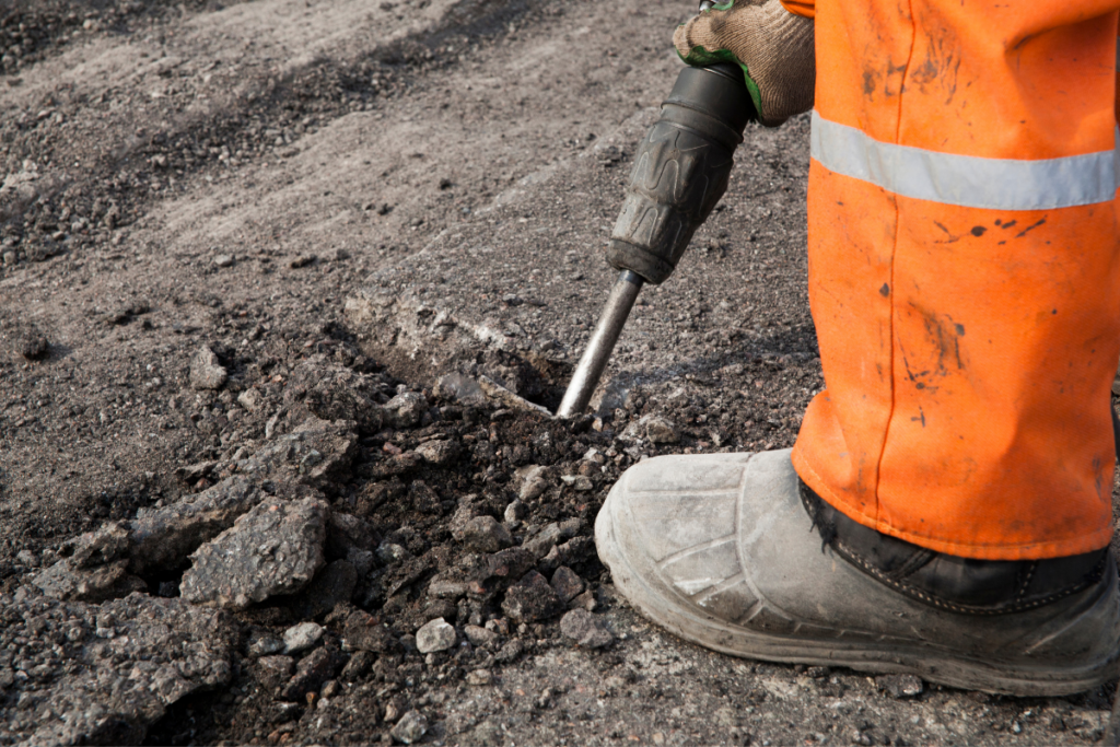 Highway maintenance crew repairing a pothole on a UK road, demonstrating where the PaveVent™ hydraulic pressure relief insert is installed.